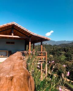a house on top of a large rock at Encontro dos Vales in Visconde De Maua