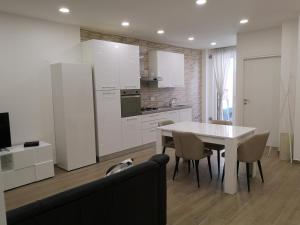 a kitchen with a white table and a white refrigerator at Appartamento Filo in Castel di Sangro