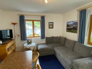 ein Wohnzimmer mit einem Sofa und einem Tisch in der Unterkunft Gästehaus Salzgau in Schönau am Königssee