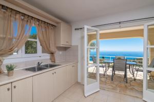 a kitchen with a view of the ocean at Armyra Villas in Volimes