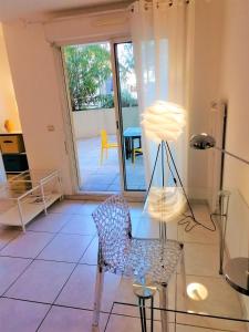a living room with a chair and a lamp at Studio neuf 25 m2, terrasse 35 m2 proche port Nice, Centre ville in Nice