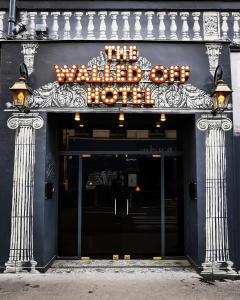 a building with a sign that reads the walnut store at Walled off Hotel Paris in Paris