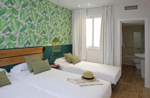 
a bedroom with a bed and a desk at Chic & Basic Lemon Boutique Hotel in Barcelona
