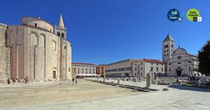 a group of buildings in a square with a church at Boutique Hostel Forum in Zadar