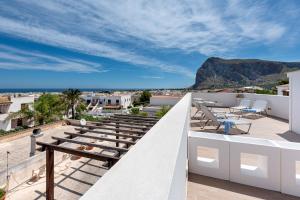 a balcony with a view of the ocean and mountains at Rivazzurra Design Rooms in San Vito lo Capo