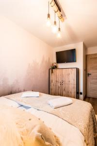 Posteľ alebo postele v izbe v ubytovaní Apartament Diamentowy Odkryj Zakopane
