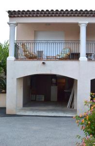 a house with a balcony with chairs on it at L'Orangeraie du Cap in Antibes