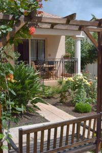 a house with a porch with a bench in the yard at L'Orangeraie du Cap in Antibes