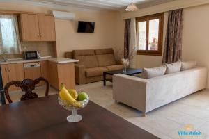 a living room with a couch and a table at Villa Arion in Nydri