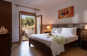 1 dormitorio con 1 cama y puerta que da a un patio en Villa Tsitreli, en Sikia
