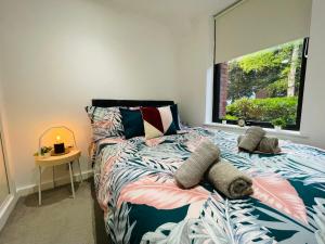 a bedroom with a bed and a window at Southernhay Court Apartments by Staytor Accommodation in Exeter