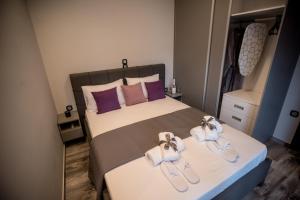 a bedroom with a bed with shoes on it at Paraiso Azul Villas in Áyios Dhimítrios +67 photos