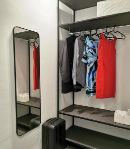 a walk in closet with a mirror and a suitcase at Veranda lake view in Como
