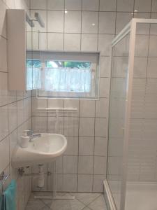 a white bathroom with a sink and a shower at Fenyves Villa in Balatonfenyves +65 photos