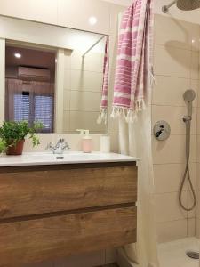 a bathroom with a sink and a shower at D João Xavier Guesthouse in Lagos