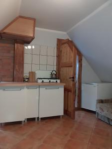 a kitchen with a stove and a counter top at U Ewy i Grzesia in Krzeszna