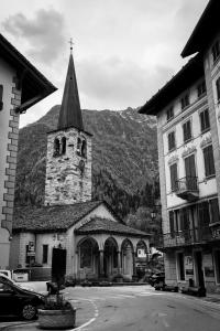 a church steeple with a clock tower at MH Cristallo in Alagna Valsesia