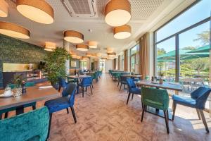 a restaurant with tables and chairs and windows at Karls Hotel in Sigmaringen