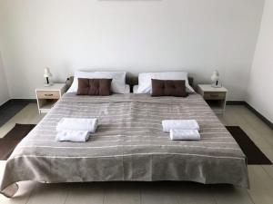 a bedroom with a large bed with two pillows on it at Apartment in Lopar with sea view, terrace, air conditioning, Wi-Fi (4607-6) in Lopar