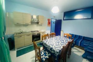 a kitchen with a table and chairs and a kitchen with a stove at Tremiti Home in Termoli