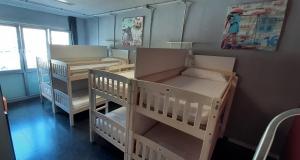 a room with two bunk beds and a window at Santander Central Hostel in Santander
