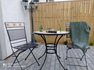 a table and two chairs on a patio at Studio Leśne in Lubniewice +11 photos