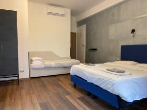 a bedroom with two beds and a mirror in it at Licia Guest House in Rome