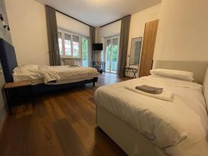 a bedroom with two beds and a television in it at Licia Guest House in Rome