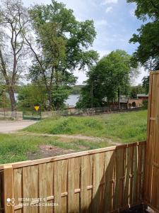 a wooden fence with a view of a field at Studio Leśne in Lubniewice