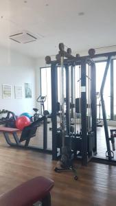 a gym with several tread machines in a room at Aleeya Suite @ Troika Residence in Kota Bharu