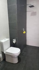 a bathroom with a white toilet in a stall at Aleeya Suite @ Troika Residence in Kota Bharu +10 photos