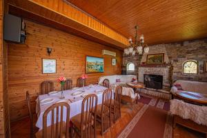 a dining room with a table and a fireplace at Sebastiano Resort in Lezhë