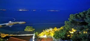 a view of the water at night at Hotel Elu Iris in Split