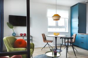 a living room with a table and chairs at ParkCity Katowice in Katowice