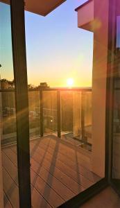 einen Blick auf den Sonnenuntergang vom Balkon eines Hauses in der Unterkunft Niechorze Amber Sunset apartment in Niechorze