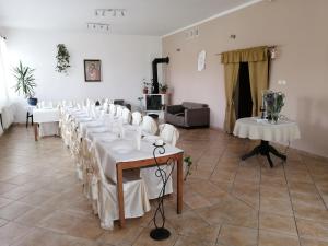 a room with white tables and white chairs at Głębia in Dąbrówno +34 photos