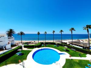 a view of a swimming pool and the beach at Marbellamar Seafront in Cabopino