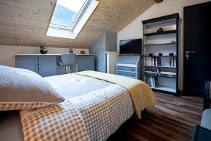 a bedroom with a bed and a skylight at B&B Restaurant Le Pernollet in Evionnaz