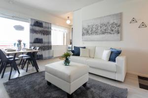 sala de estar con sofá blanco y mesa en Tuomas´ luxurious suites, Rakka, en Rovaniemi