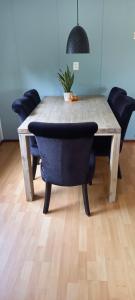 a wooden table with chairs and a potted plant on it at 't uiltje in Ermelo +31 photos