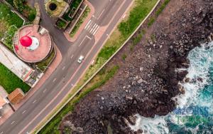an aerial view of a road and the ocean at Boina de Vento in Santa Cruz da Graciosa
