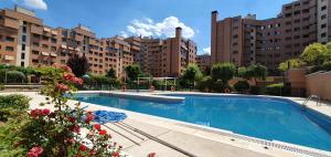 a large swimming pool in front of some buildings at Residencial Caliza in Madrid