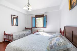 A bed or beds in a room at La Pontezuela Alanis