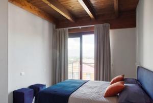 a bedroom with a bed and a large window at Residenza Puoti in Peschiera del Garda