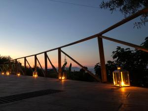 a group of lights on a patio at sunset at mammaCristina in Patti