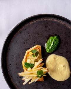 a plate of food with pasta and a pickle at Hawkstone Hall Hotel & Gardens in Shrewsbury