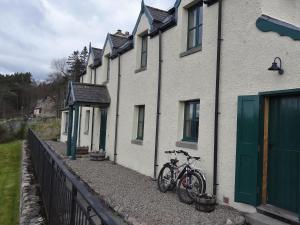 a couple of bikes parked outside of a house at The Cottage Bogroy in Carrbridge