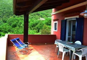 a blue chair and a table on a patio at Le case di Nina in Maratea