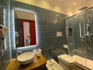 a bathroom with a sink and a toilet and a shower at Holiday Guesthouse in Salerno +51 photos