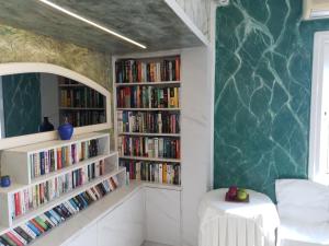 a room with two book shelves filled with books at Korifi Apts & Std Adults Only in Hersonissos